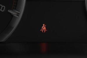 Seat belt warning light on car dashboard. Safety restraint law, safety concept. photo