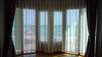 curtain and window with sea beach outside view video