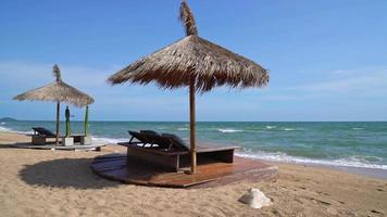 beach chair on beach with sea and blue sky background video