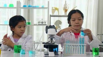 dos niñas de la escuela que estudian ciencias en el aula estudiante aprendiendo en el laboratorio video