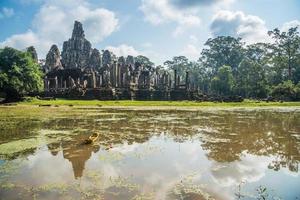 The spectacular reflection of Bayon a mountain temple built to represent Mount Meru, the center of the universe in Hindu and Buddhist cosmology, Siem Reap of Cambodia. photo