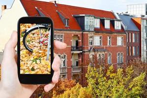 tourist photographs of fallen leaves on street photo