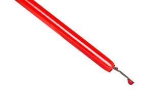 side view of ink drop in red dip pen close up photo