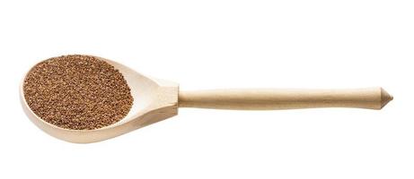 whole-grain teff seeds in wooden spoon isolated photo