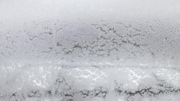 frosted home window in urban houses in winter photo