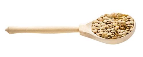 spoon with raw whole light green lentils isolated photo