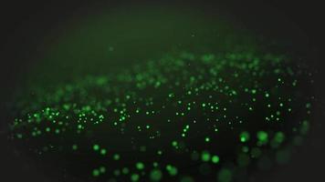 green particle wave background. The green particles glow with the theme of the micro world With a beautiful and mysterious black background video