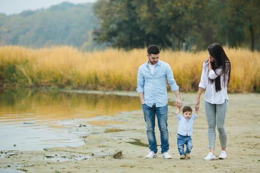 Young family walking at the beach photo