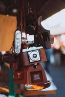 Old camera hanging on a city street photo