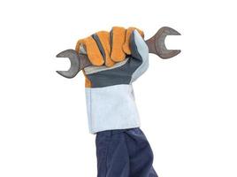 Hand in glove holding spanner on white photo