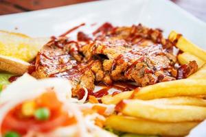 Grilled pork steak with salad on a plate photo