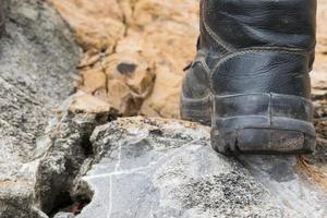 Trekking leather boot on the rock photo