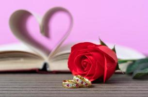 Pages of book curved  heart shape with wedding ring photo