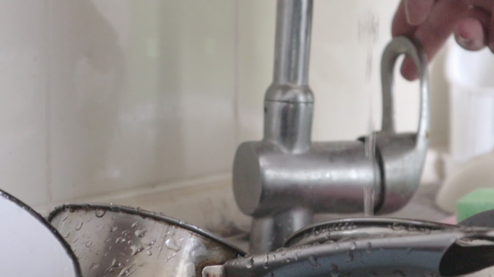 Closeup of the kitchen sink turning off the water. Men's hands washed