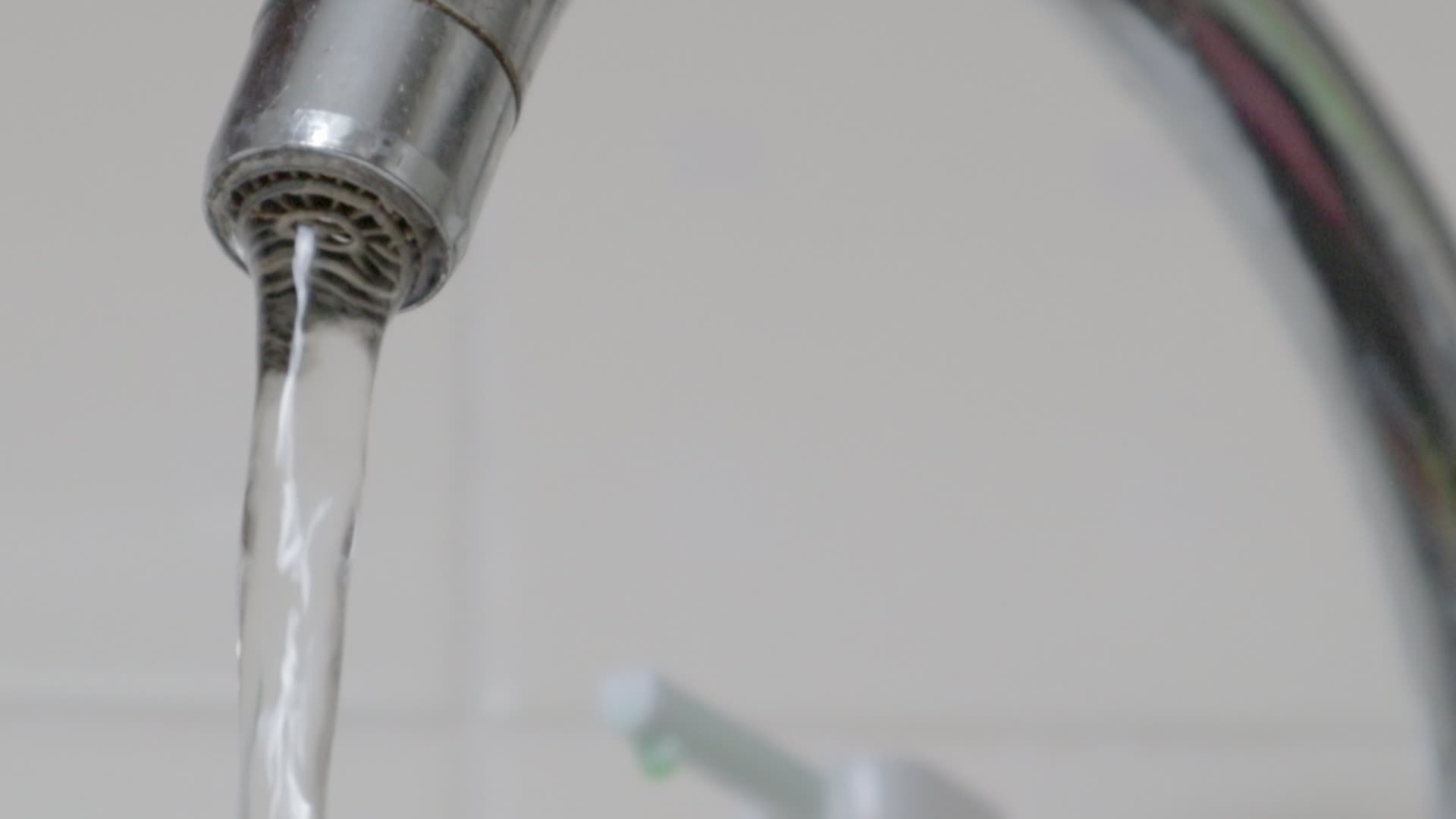 Close up of drinking tap water flowing from a faucet. Designing a faucet in the kitchen or bathroom. The concept of water saving and water consumption tariff and price of water