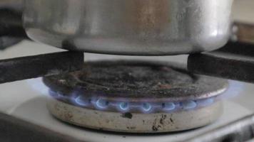 Saucepan on fire close-up. Cooking in a pot on a gas stove. Gas burner on the kitchen stove for cooking. Kitchen gas stove with burning propane fire. Natural gas concept. video