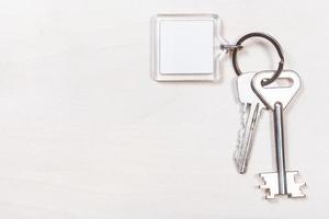 pair of door keys on keyring with blank keychain photo