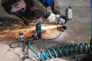 mechanic cuts new pipe for corrugation silence photo