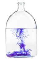 violet watercolour dissolves in water in flask photo