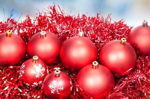 Xmas red balls and tinsel on blue background photo