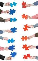 red and blue puzzle pieces in people hands photo