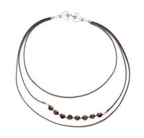 leather strip and bone beads necklace isolated photo