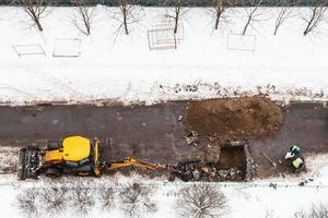 above view of workers and tractor digging road photo