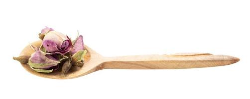 old dried rosebuds in wooden spoon isolated photo