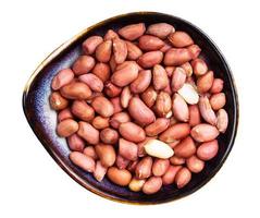 view of shelled peanuts in ceramic bowl isolated photo