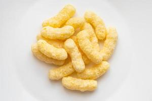 pile of corn puffs on white plate photo