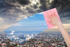 hand deletes dirty city by pink cloth photo