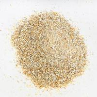 top view of pile of rye bran close up on gray photo