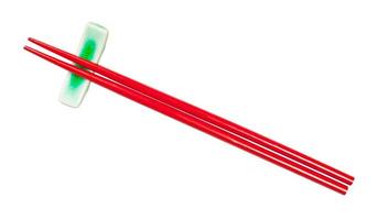 top view of red chopsticks on chopstick rest photo