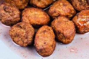 cooked swedish meatballs on blue plate close up photo