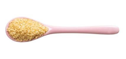 view of demerara brown cane sugar in ceramic spoon photo