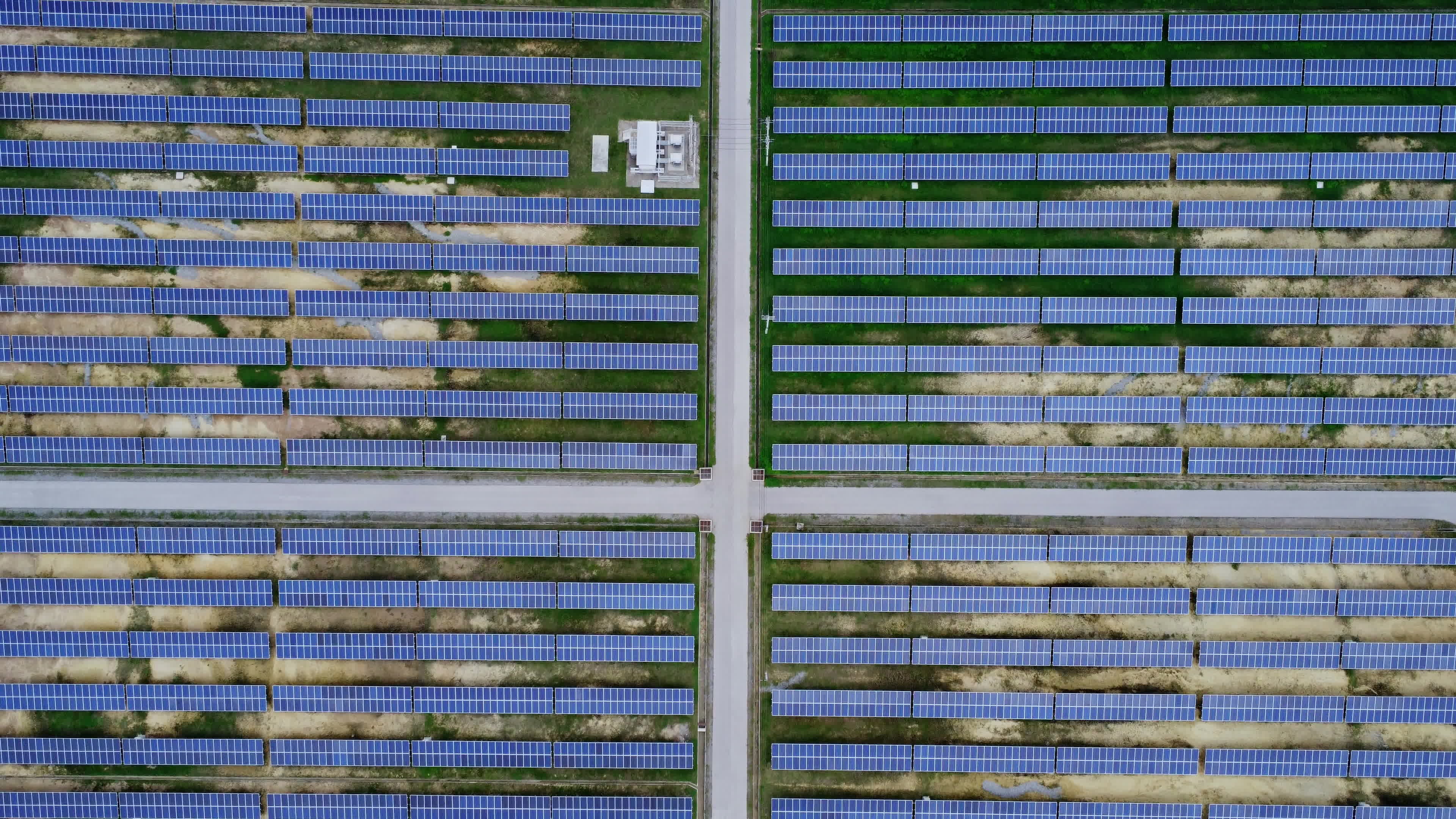 aerial-view-of-solar-power-plant-on-green-field-solar-panels-system