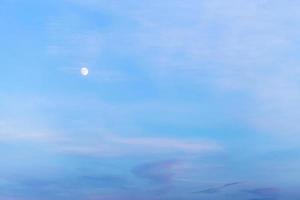 white moon in blue evening sky photo