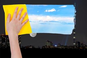 hand deletes night over city by yellow cloth photo