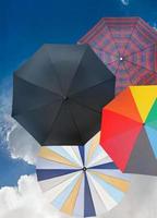 four different open umbrellas with dark blue sky photo