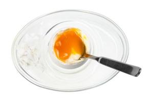 top view of soft egg with spoon in glass egg cup photo