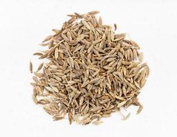 pile of cumin cuminum cyminum seeds close up photo