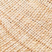 texture of straw hat from interwoven raffia fibers photo