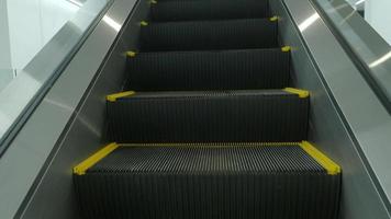 Close up shot of empty moving staircase running up and down. video