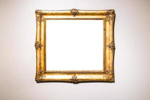 old wide baroque gold picture frame on brown wall photo