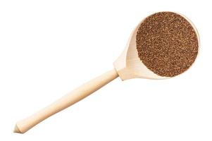 top view of whole-grain teff seeds in wood spoon photo