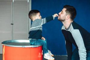 little boy and father playing together photo