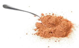 spoon in pile of cocoa powder isolated photo