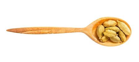 view of wood spoon with cardamom seeds isolated photo