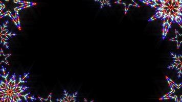 A slow colour changing looped illuminated animation video of Christmas star and snowflake shapes made with real LED Christmas lights and filter added to imitate a stage screen style border frame