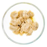 buttered Pelmeni in glass bowl isolated on white photo